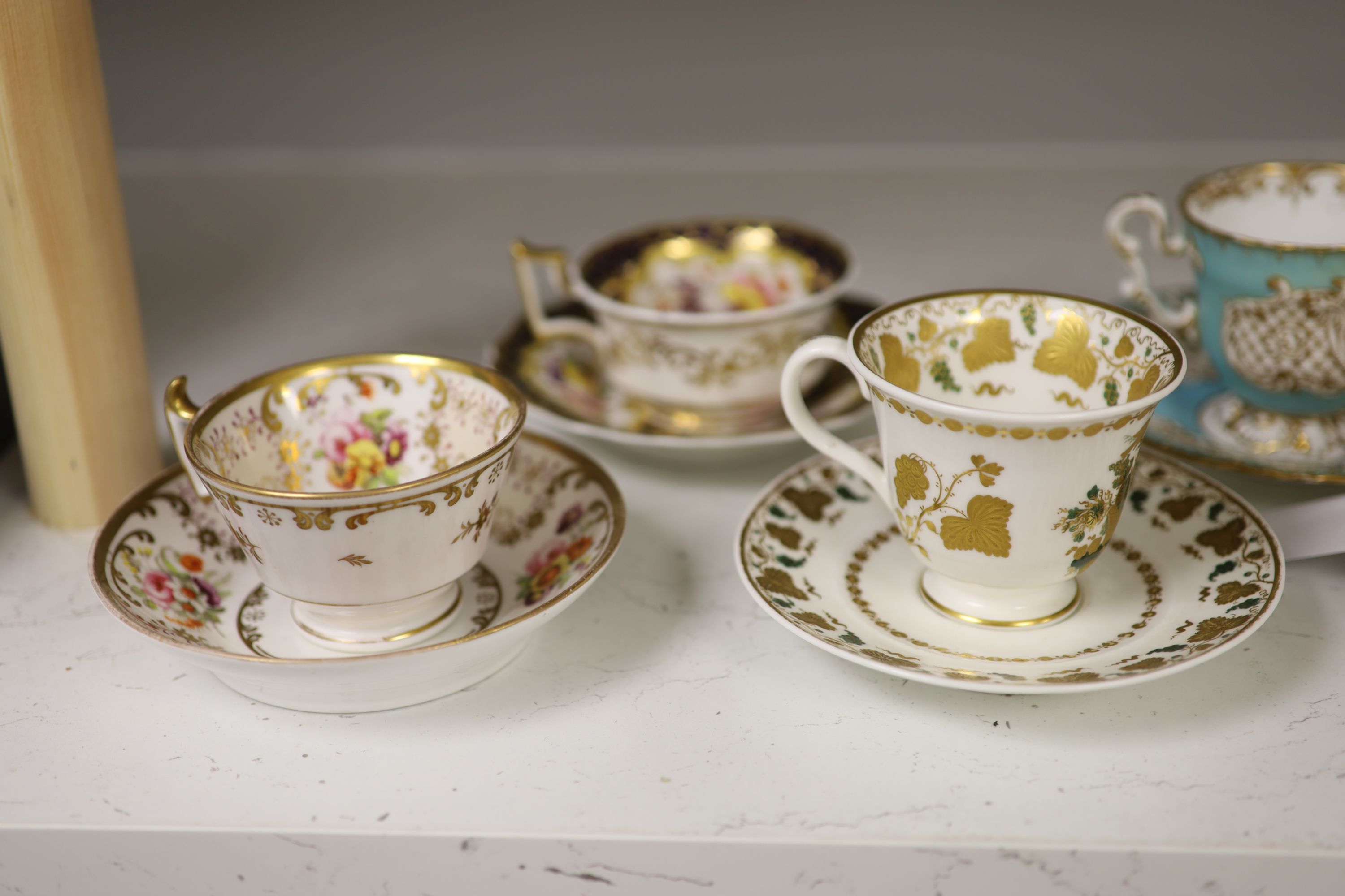 A Spode cup and saucer decorated with raised gilt birds and a basket with green leaves, marked Spode 3916, a Copeland and Garrett turqu